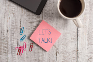 Handwriting text writing Let S Is Talk. Concept meaning suggesting in the beginning of a conversation on the topic Stationary placed next to a cup of black coffee above the wooden table.